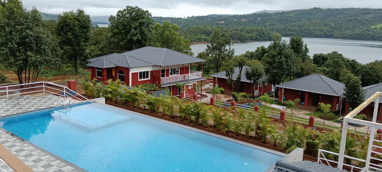 Pool with scenic hill views at Aranyagiri